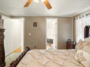 Bedroom featuring ceiling fan, ensuite bathroom, and wood finished floors