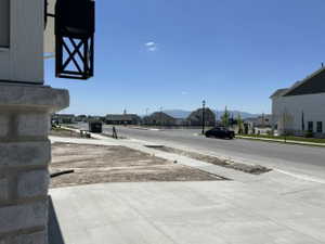 View of asphalt road with sidewalks and a mountain view