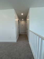 Corridor featuring carpet floors, recessed lighting, and baseboards