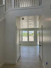 Corridor featuring baseboards and light wood finished floors