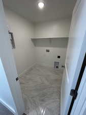 Washroom featuring light marble finish flooring, baseboards, washer hookup, and recessed lighting