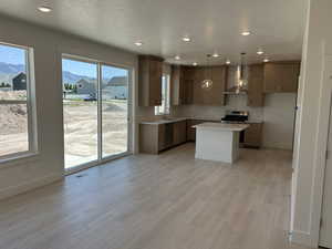 Kitchen with a sink, stainless steel appliances, light countertops, tasteful backsplash, and baseboards