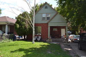 View of front facade with a porch and brick siding