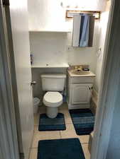 2nd floor full Bathroom with toilet, vanity, tile patterned flooring, and a textured wall