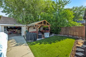 View of yard with a garage, an outdoor structure, and a gazebo