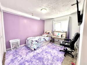 Bedroom featuring a textured ceiling