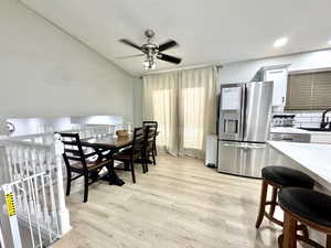 Dining space featuring ceiling fan, light wood-style floors, and recessed lighting