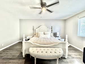 Bedroom featuring wood finished floors, baseboards, a textured ceiling, and ceiling fan