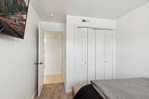 2nd large sized Bedroom with new carpet, upgraded padding, and a textured ceiling.