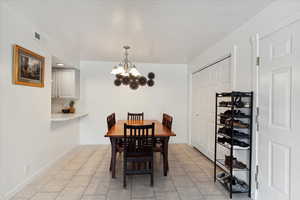 Dining area with a chandelier, open to the kitchen for easy conversations when entreating guests.