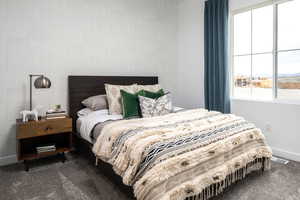 Carpeted bedroom featuring baseboards