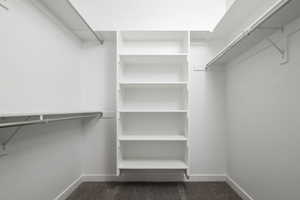 Walk in closet with dark carpet