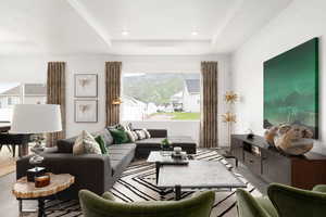 Living room with wood finished floors, a tray ceiling, and recessed lighting