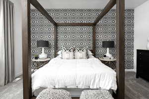 Carpeted bedroom featuring baseboards