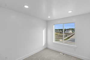 Bedroom 2 featuring baseboards, light carpet, and recessed lighting