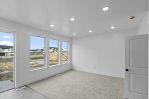 Living room featuring 9' ceilings, large windows, and recessed lighting