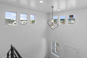 Detailed view of a chandelier and recessed lighting over 2 story entry