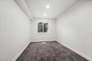 Carpeted spare room featuring recessed lighting and baseboards