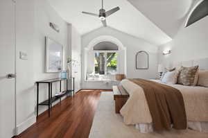 Bedroom with lofted ceiling, hardwood / wood-style flooring, and a ceiling fan