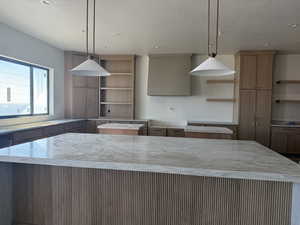 Kitchen with open shelves, a kitchen island, premium range hood, pendant lighting, and recessed lighting
