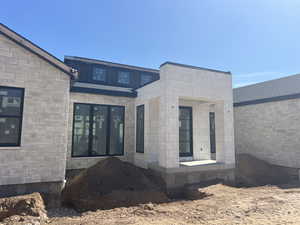 View of exterior entry featuring stone siding