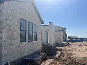 View of side of home with stone siding