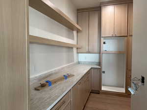 Kitchen with dark wood finished floors and light countertops