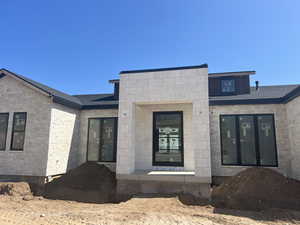 Back of property with stone siding