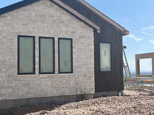 View of side of home with stone siding