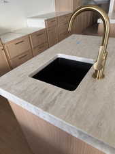 Kitchen view of a sink and light brown cabinets