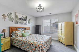 Carpeted bedroom featuring baseboards