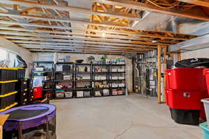 Basement featuring secured water heater and heating unit