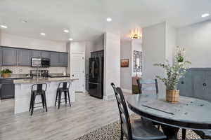 Dining space with recessed lighting, light wood-style flooring, and baseboards