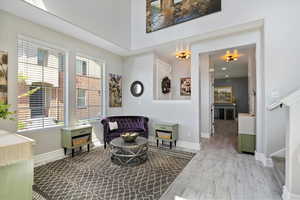 Living area featuring wood finished floors, baseboards, and stairs