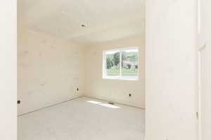 Empty room featuring baseboards and light floors