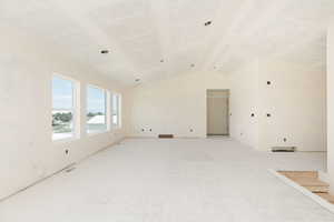 Spare room featuring lofted ceiling