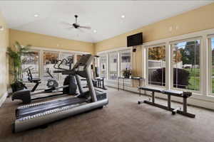 Exercise room in the clubhouse featuring a ceiling fan, carpet, and recessed lighting