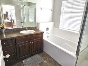 Master bath with a garden tub, a shower & sink