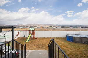 View of yard featuring a playground, a residential view, and a mountain view