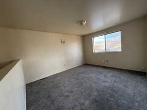 Empty room with carpet flooring and baseboards