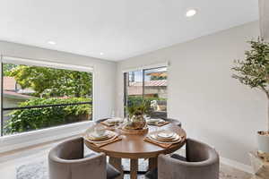 Dining area featuring light wood-style flooring, baseboards, and recessed lighting