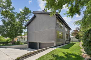 View of home's exterior with an attached garage and driveway
