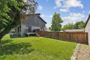 OCCUPIED SIDE View of yard featuring a wooden deck and stairway