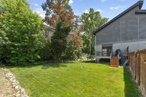 OCCUPIED SIDE. View of yard with stairway and a deck
