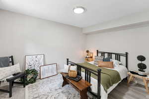 Bedroom with wood finished floors and baseboards