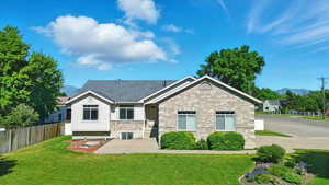 View of front of property featuring a mountain view, stucco siding, and brick siding