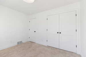 Unfurnished bedroom featuring carpet floors and baseboards