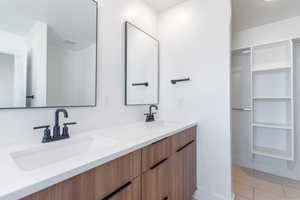 Master bathroom with double vanity and baseboards