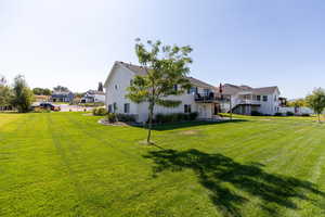 View of grassy yard with a residential view and a wooden deck