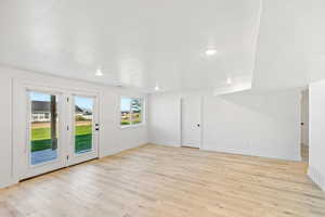 Empty room featuring light wood-type flooring, baseboards, and recessed lighting